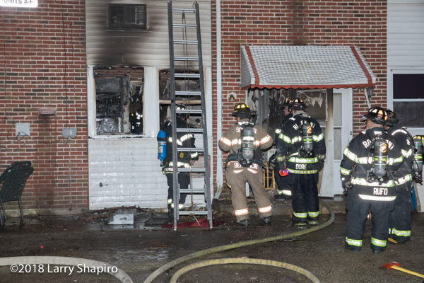 firefighters after battling an apartment fire