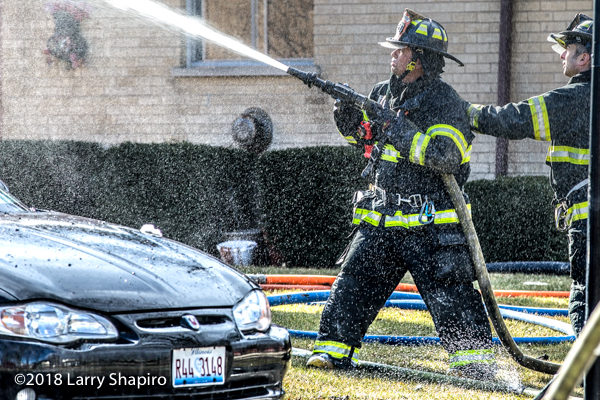 firefighter with hose line at fire