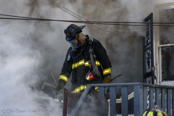 firefighter in PPE surrounded by smoke