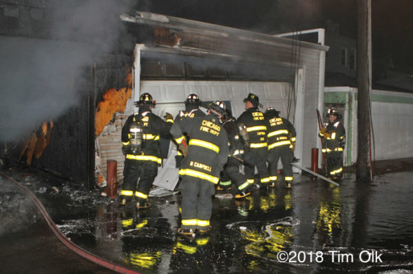 Firefighters after alley garage fire