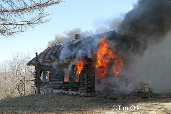 log cabin house engulfed by fire