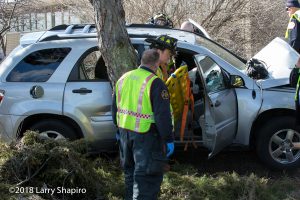 Firefighters attend to car crash victim