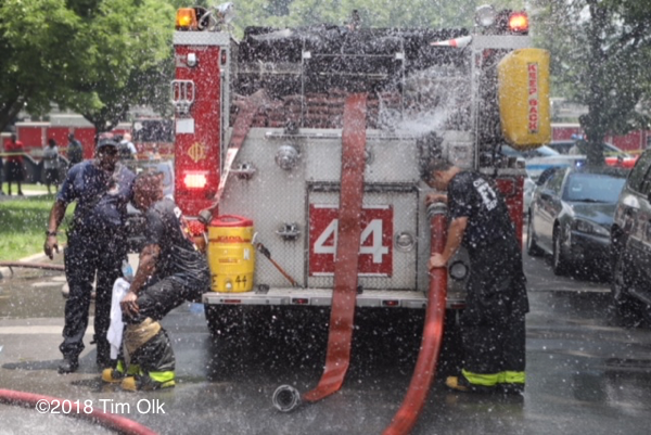 Firefighter cools down on a hot day