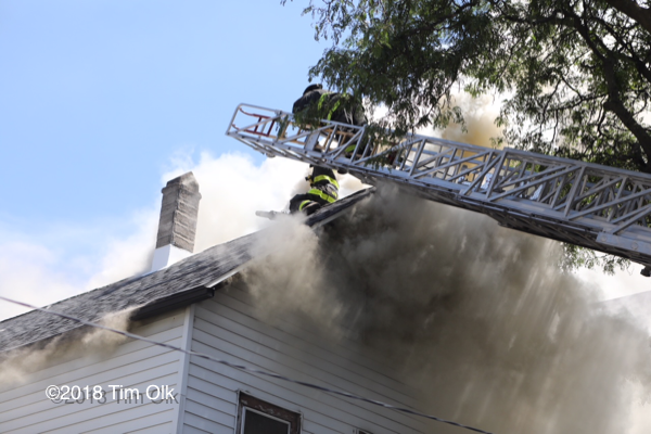 heavy smoke vents from attic of house