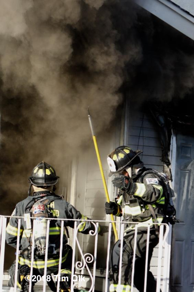Firefighters battle a house fire
