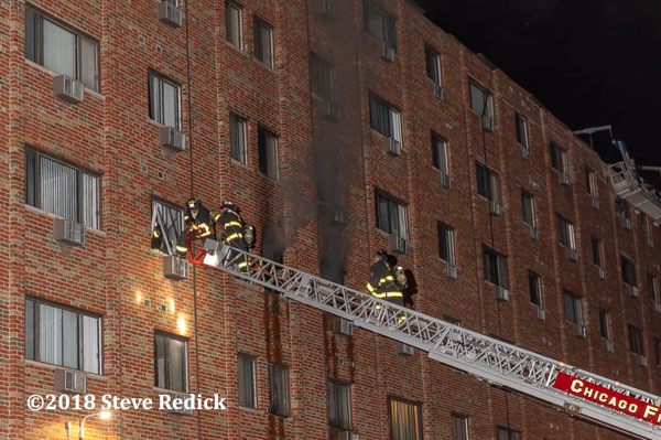 Chicago Firefighters work off aerial ladder