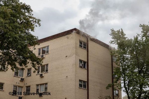 smoke from roof of apartment building