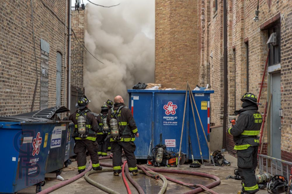 heavy smoke in alley from commercial building fire