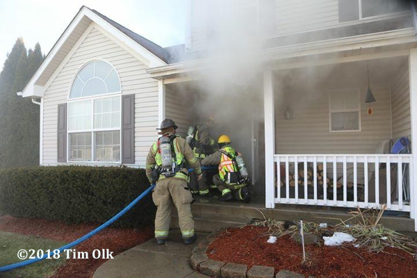 Firefighters enter house on fire