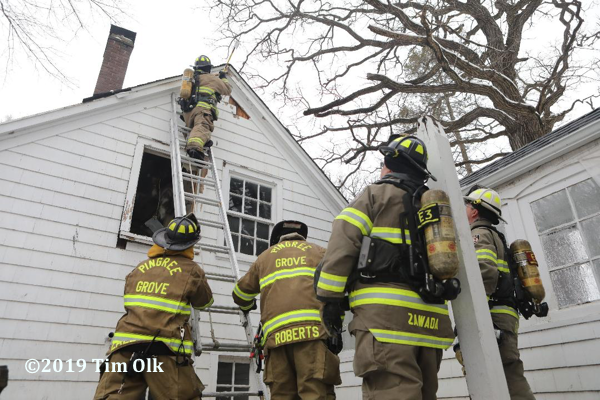 Firefighters overhaul house after a fire