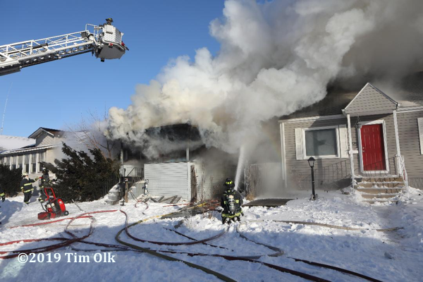 Firefighters battle house fire in frigid weather