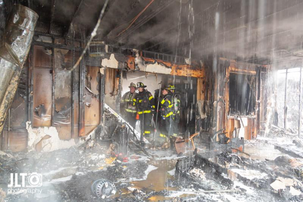 Firefighters overhaul after house fire