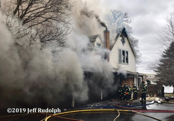 Firefighters battle fire in a large house