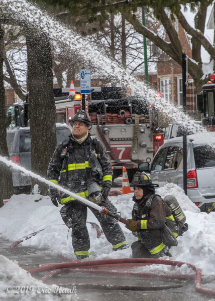 Firefighters with hose line in the winter