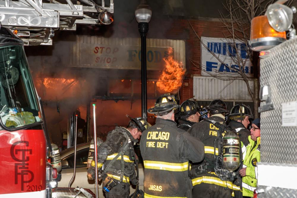 Chicago Firefighters battle storefront fire at night