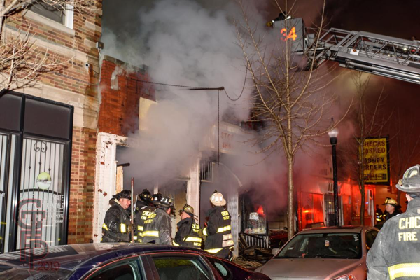 Chicago Firefighters battle storefront fire at night