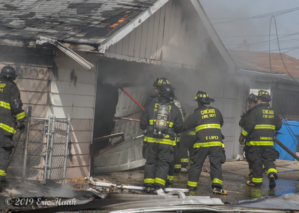 Firefighters fight alley garage fire