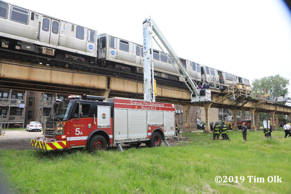 Chicago Firefighters remove civilians from an elevated train derailment