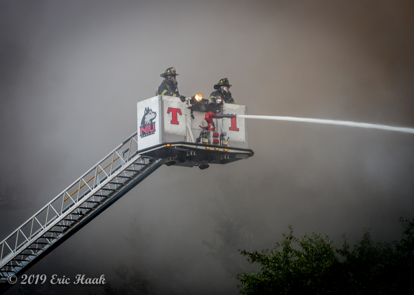 Firefighters in tower ladder bucket