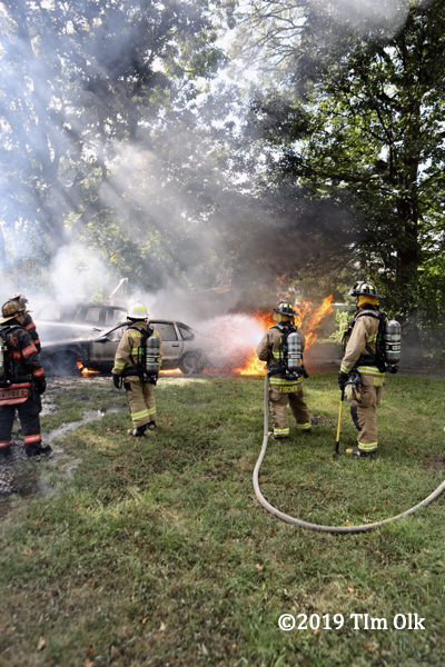 firefighters battle a car fire
