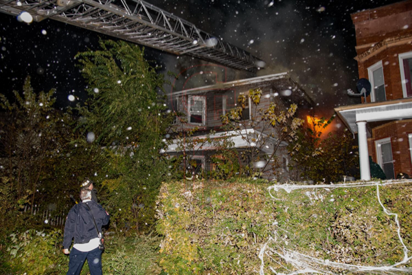 Firefighters battle house fire at night
