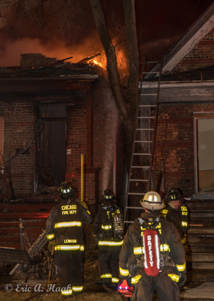 Firefighters working at night with hose line