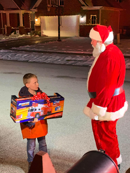 Santa, a boy, and a fire truck toy