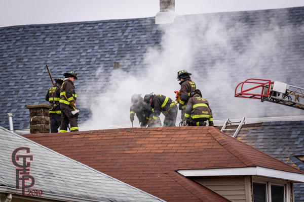 Firefighters vent roof during a fire