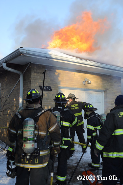 Firefighter cuts through garage door