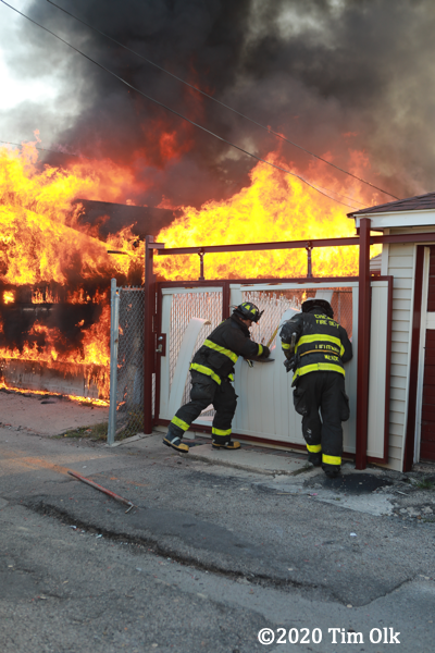 flames engulf alley garages
