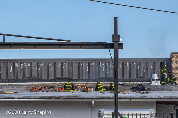 Firefighters venting a roof