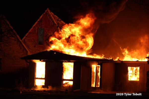 house engulfed by fire at night
