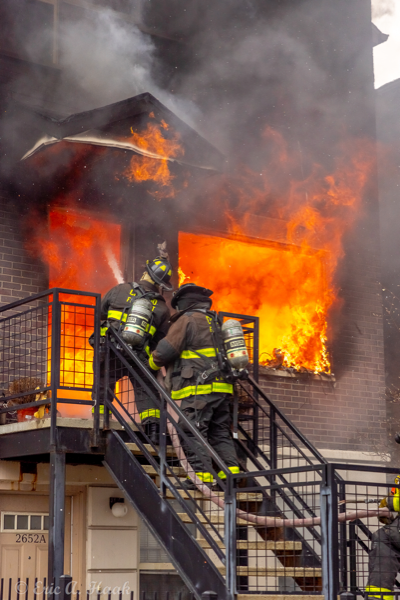 Firefighters battle fire in a two-flat building