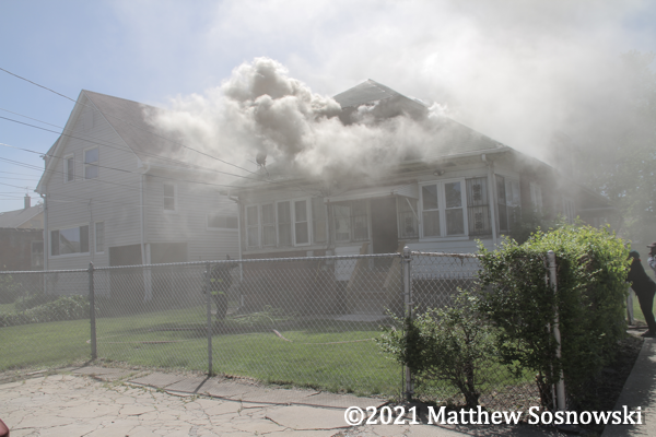 smoke billows from house on fire
