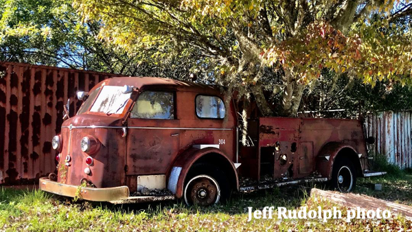vintage Calumet City fire engine rusting in a field