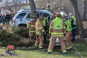 Firefighters attend to car crash victim